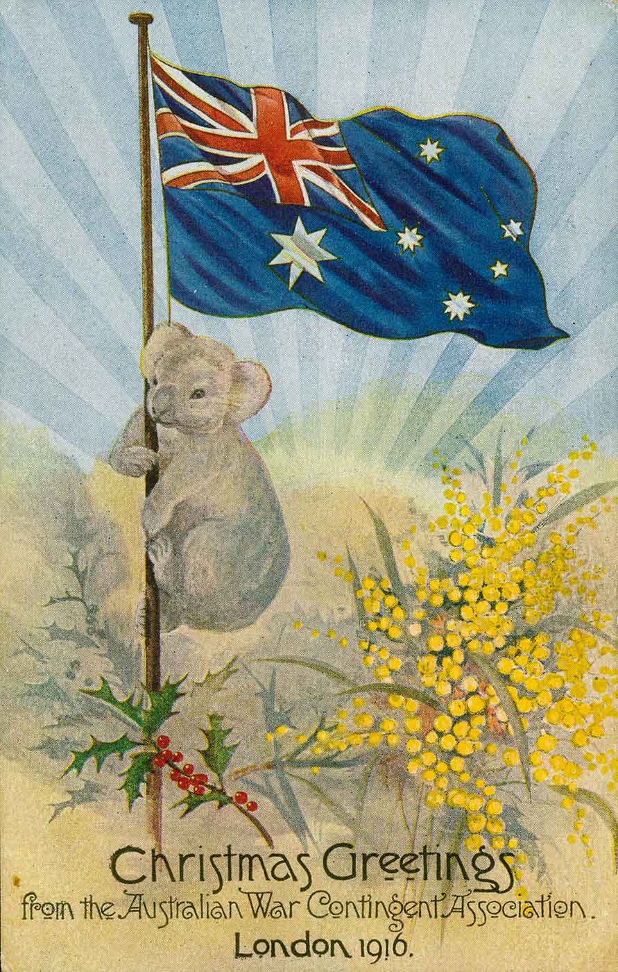 Postcard with an image of a koala climbing a flag pole which has the Australian flag at the top. There is a sprig of holly and a spray of wattle at the base of the flag pole. Text across the bottom reads 'Christmas greetings from the Australian War Contingent Association., London 1916.' - click to view larger image