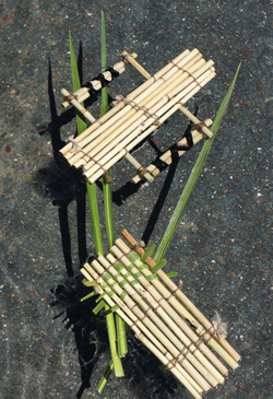 A colour image of a hand-craft raft model made from bamboo and twine