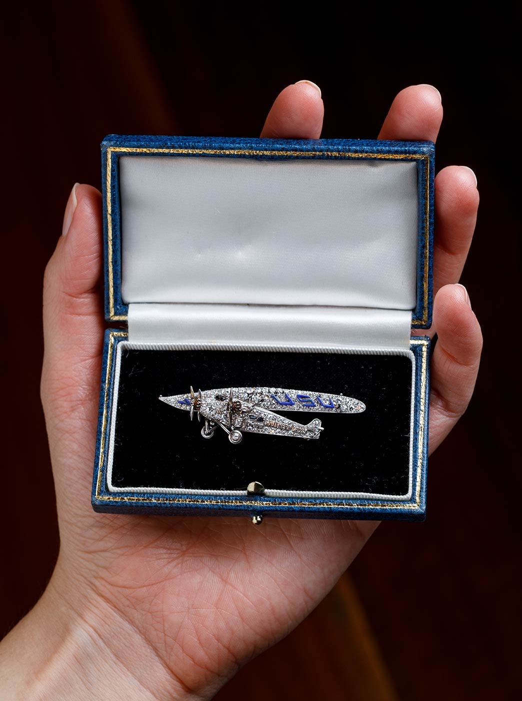 A diamond and platinum brooch in the shape of a plane. - click to view larger image