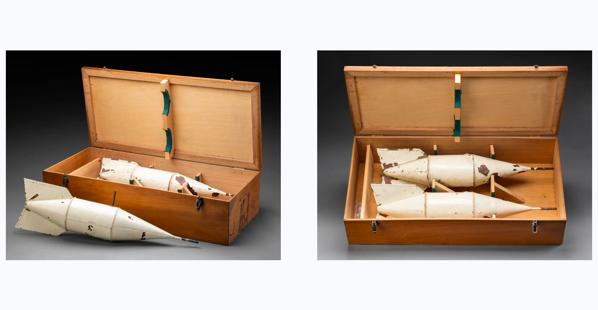 A wooden box housing two snow gauges. The wooden box consists of a hinged lid with two over centre latches. The interior consists of timber framing with green padded lining in the base and underside of the lid. There is also a small compartment to one side of the box. Each snow gauge comprises several sections including a central copper cylinder and two long conical ends. On one end are two metal fins and on the other is a thin metal pipe, one from which a tiny metal pipe has been welded. There is also a thin metal pipe running through the central cylinder near its edge. The gauges are painted cream and feature either a '13' or '3' stencilled in black on their sides.