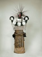 A mourning dress formed of cock’s feathers fastened to a kind of netting made of cordage with sticks. Head-piece made of two large mother-of-pearl shells.