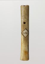 Flute made of long bone, perforated on one side.