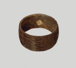 Bracelet made from the central strip of the hard coconut shell. A zigzag pattern has been cut into the outside, running all round in a repeat pattern.