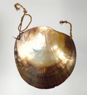 Breast ornament consisting of mussel shell that has been sanded and polished.