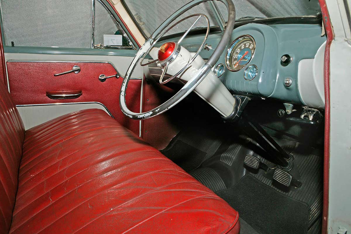 Interior view of the FJ featuring the dashboard, steering wheel and red leather upholstery.