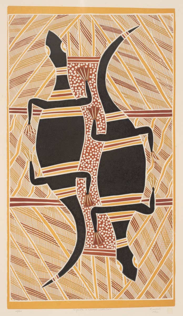 An Australian Indigenous linocut print on paper. The print is in portrait format ie the vertical sides are longer than the horizontal sides. It depicts what appear to be two goannas, next to each other but facing in opposite directions. The goannas are black with red and yellow bands across them. Between them is an area of red with a traditional white dot pattern. The remainder of the print is covered in traditional line patterns, in yellows, reds and ochres. - click to view larger image