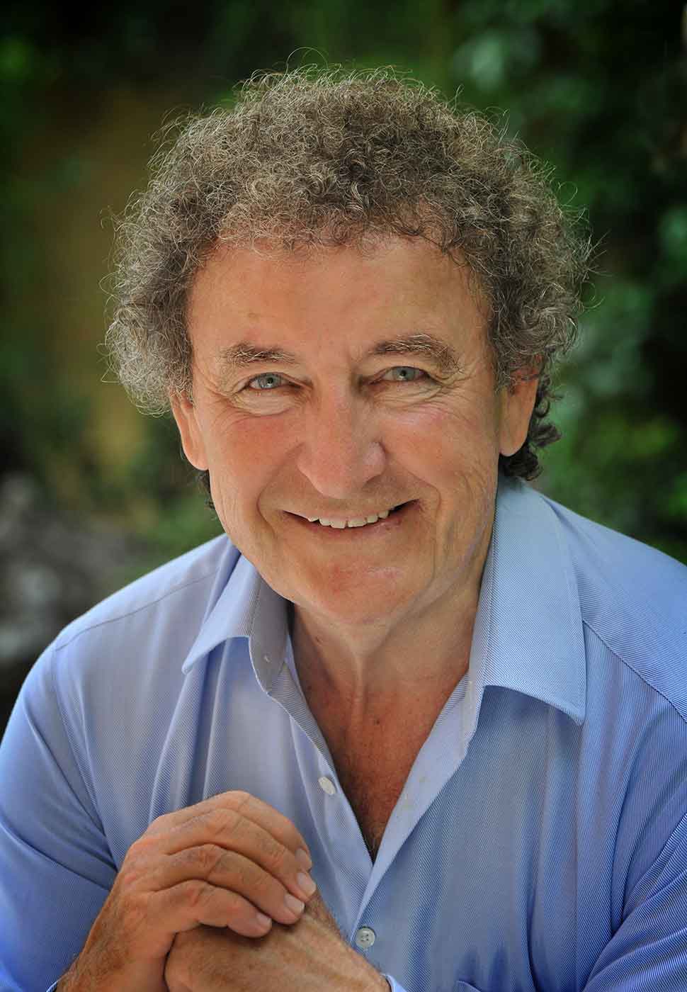 Photo portrait of middle-aged man in a blue shirt. - click to view larger image