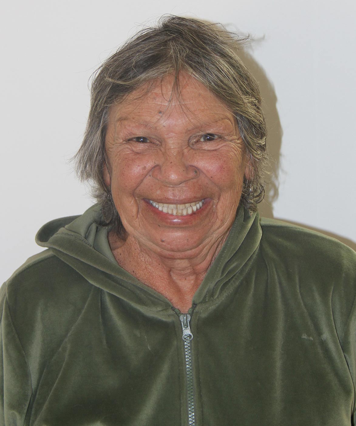 Portrait of an elderly woman with a broad smile. - click to view larger image