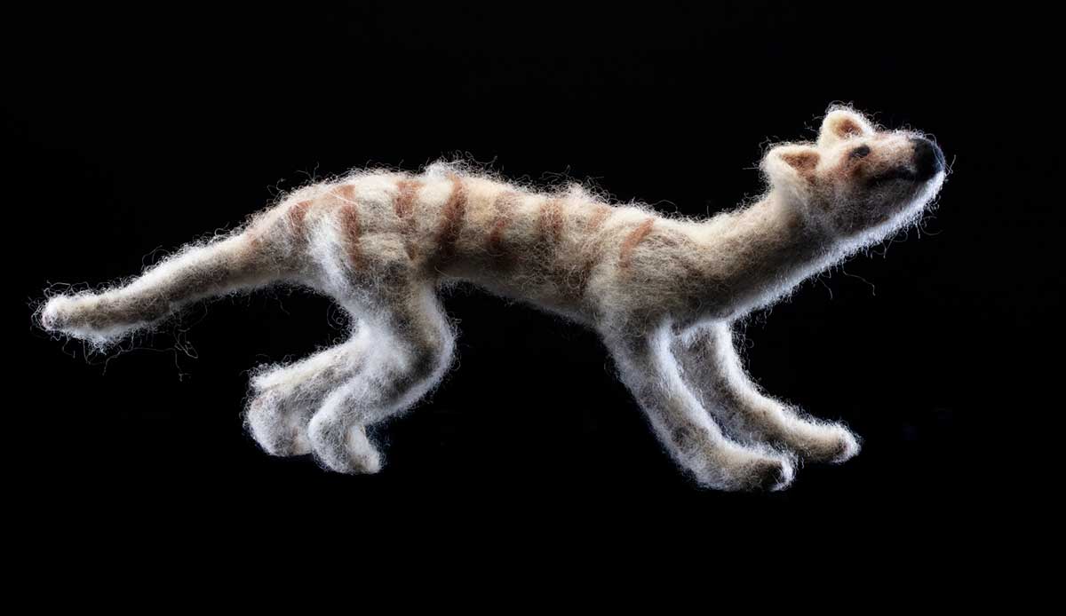 A sculpture of a thylacine joey with a felted exterior. - click to view larger image