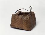 Basket made of pandanus leaves weaved into alternating narrow stripes in a brown or yellowish colour.