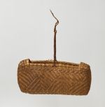 Basket made of pandanus leaves of yellowish and brown strips with a torn handle of plaited coconut fibre.