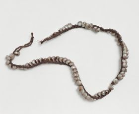 Ornamental band made of small Trochi Shells, and plaited together from sinew cord.