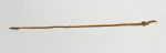  long knotted staff or club made of wood nearly in its natural shape. The lower end is wrapped in coconut fibre.