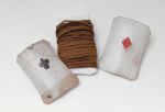 Cord made of coconut fibres and wound round old English playing cards.