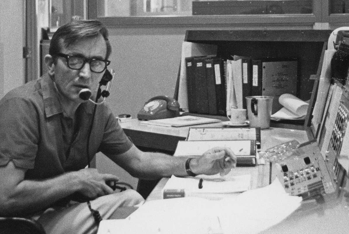 Photo of Tom Reid at Honeysuckle Creek’s operations console during Apollo 8.