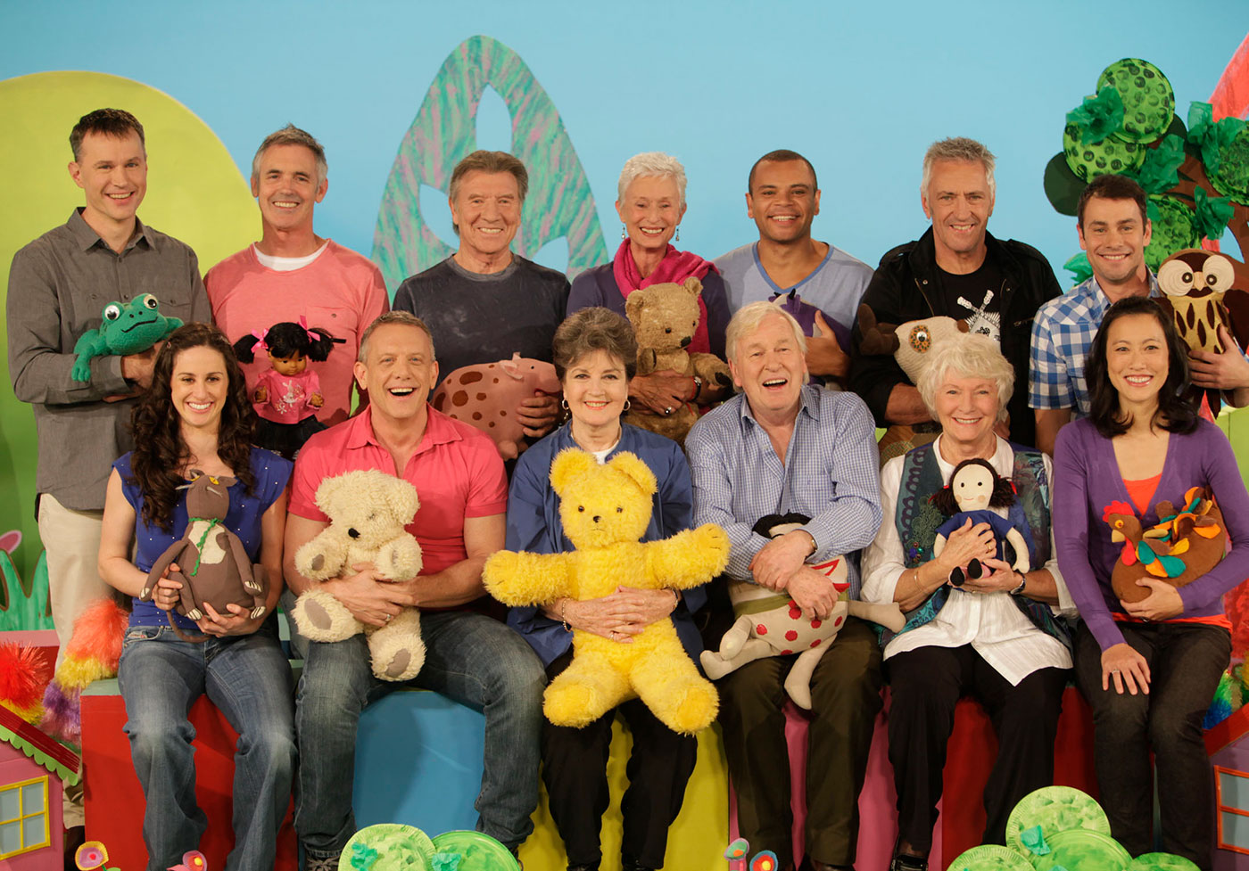 A group shot of Play School presenters and toys on set.