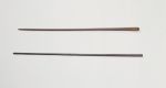 Clubs made of brown, heavy wood, one of nearly black wood.