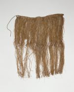 Skirt or apron made from fine shred of plantain leaf, dyed and knotted to a string that fastens around the waist.