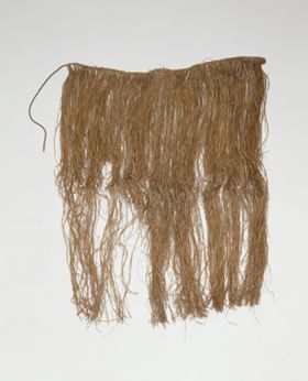 Skirt or apron made from fine shred of plantain leaf, dyed and knotted to a string that fastens around the waist.