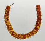 Feathered necklace that consists of yellow and red feathers, tightly arranged in circles.