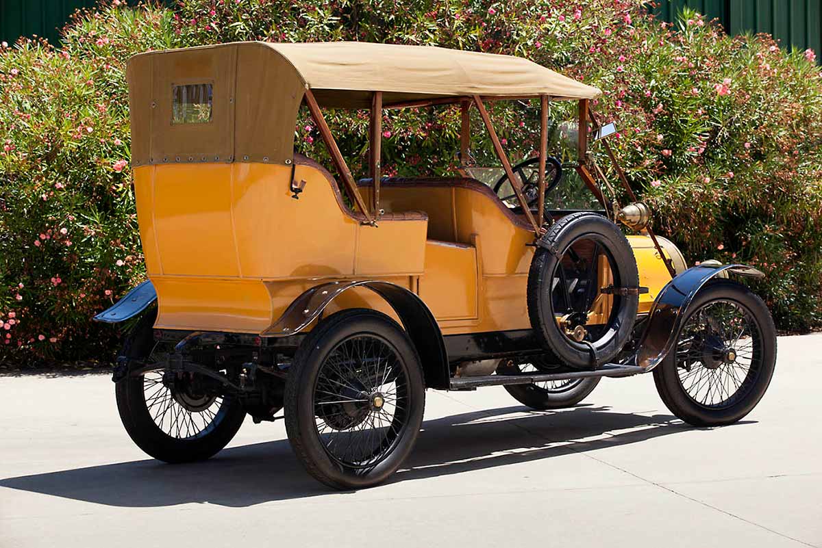 An automobile featuring a yellow body, black mudguards and running boards. - click to view larger image