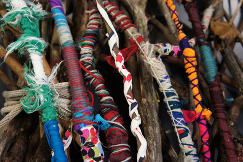 Sticks covered in colourful fabrics.