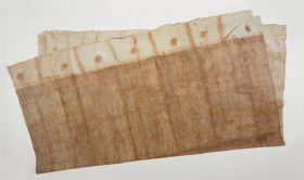 Large piece of glazed barkcloth decorated with a pattern of diagonal and vertical brown lines with a white border and large brown spots and stripes at both ends.