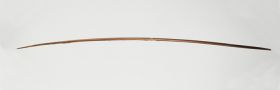 Short bow made of brown wood that tapers sharply towards both ends.