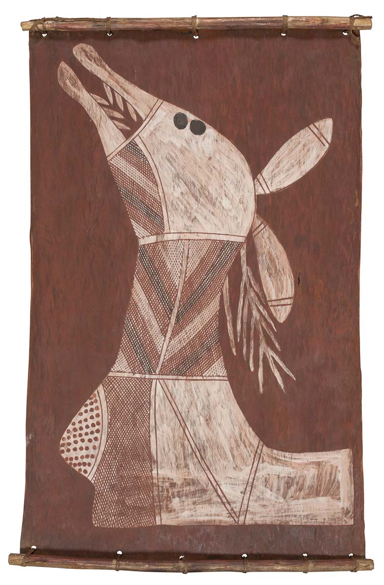 A bark painting worked with ochres on bark and on wooden restrainers. It depicts the head and shoulder of an animal crosshatched in brown, black and white, and segmented with white bands and with brown spots on a white upper chest. - click to view larger image