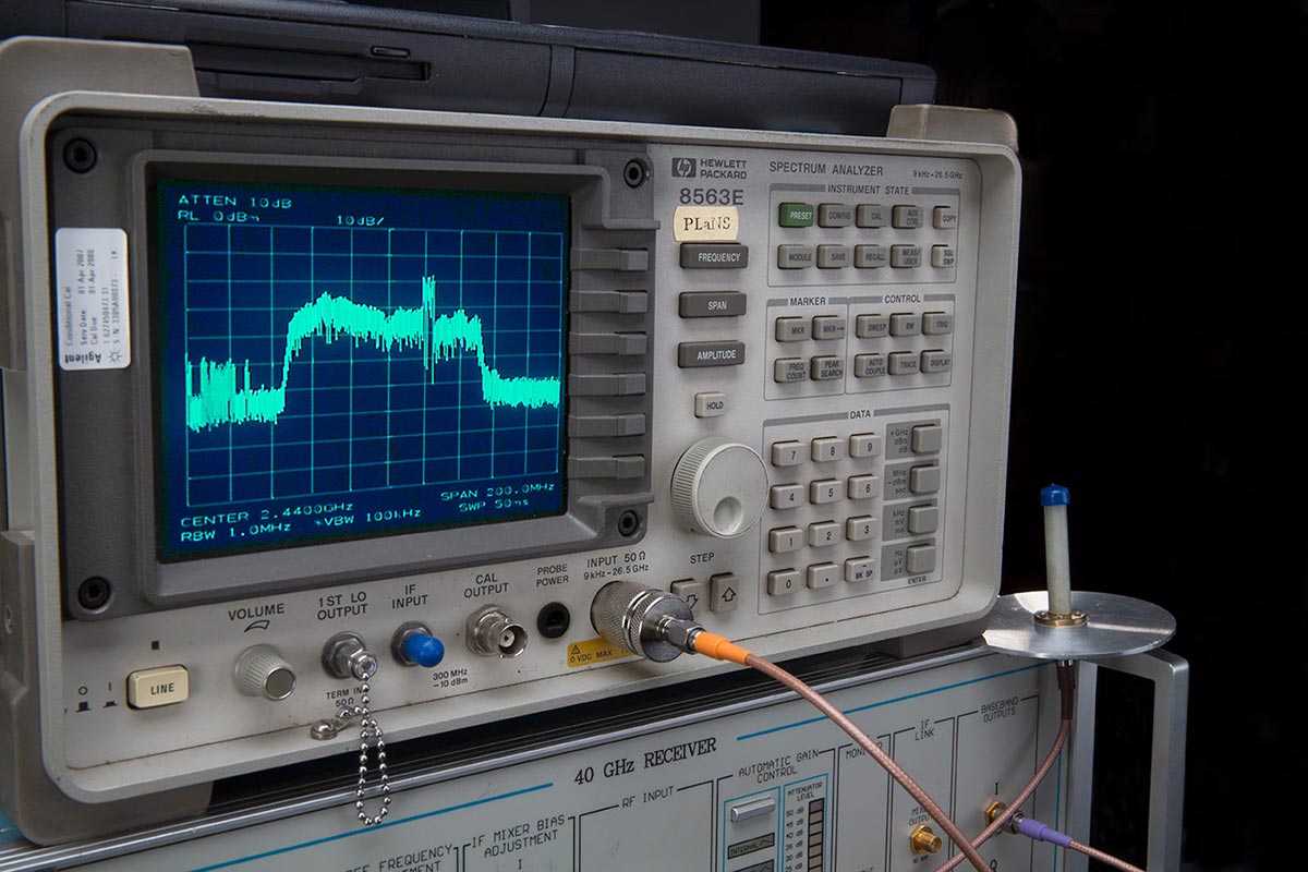 A piece of equipment with a small screen showing a frequency wave.