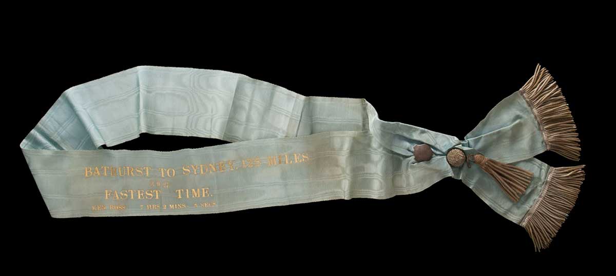 Light blue sash with gold fringing and gold lettering. - click to view larger image