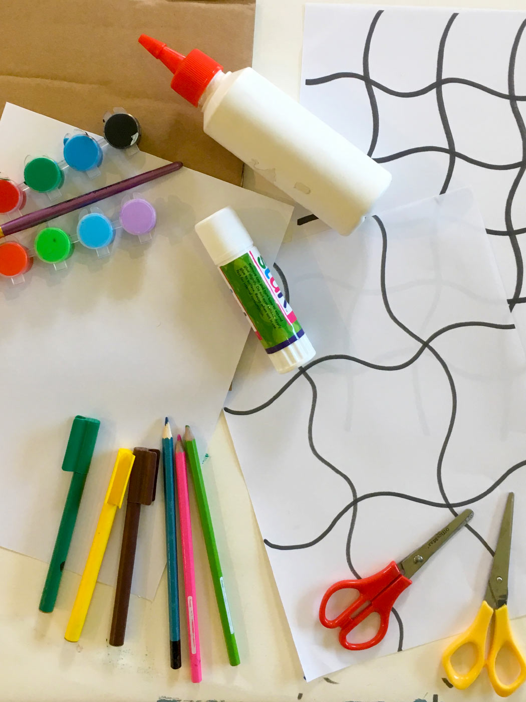 Craft materials including pencils, textas, paints, glue, scissors and a puzzle template.